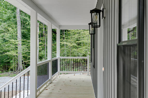 A charming wooden porch with stylish features and inviting furniture, blending modern and farmhouse elements, creating a harmonious and inviting space in fall season.